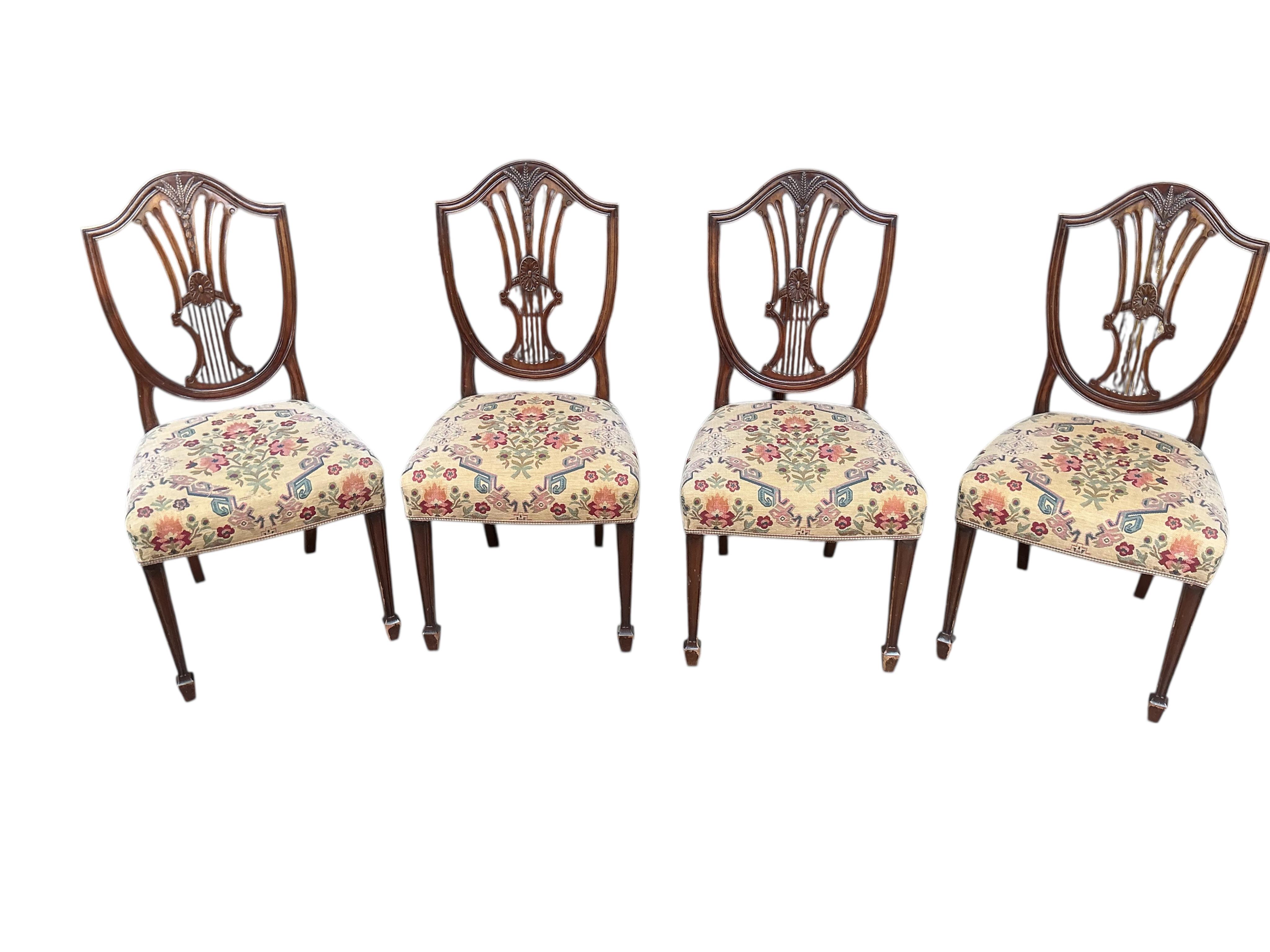 A set of eight George III style mahogany shield back dining chairs, two with arms